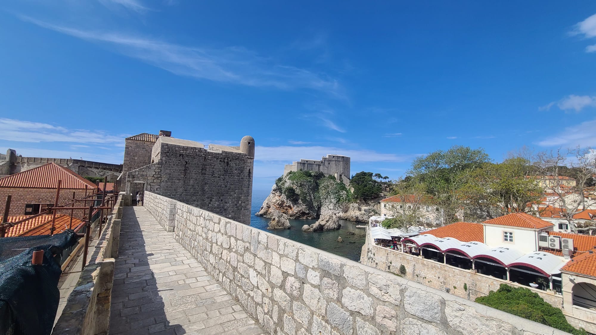 Fort Collins luxury travel advisor views Dubrovnik’s walls and old town from the city walls, with the Adriatic beyond.